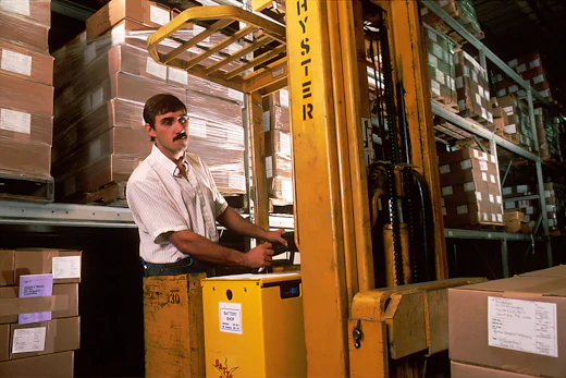 Forklift loading goods at warehouse dock