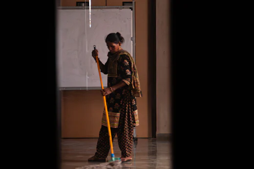 Housekeeping staff mopping a polished floor